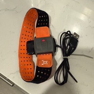Orange and Black Heart Rate Monitor used at Orange Theory